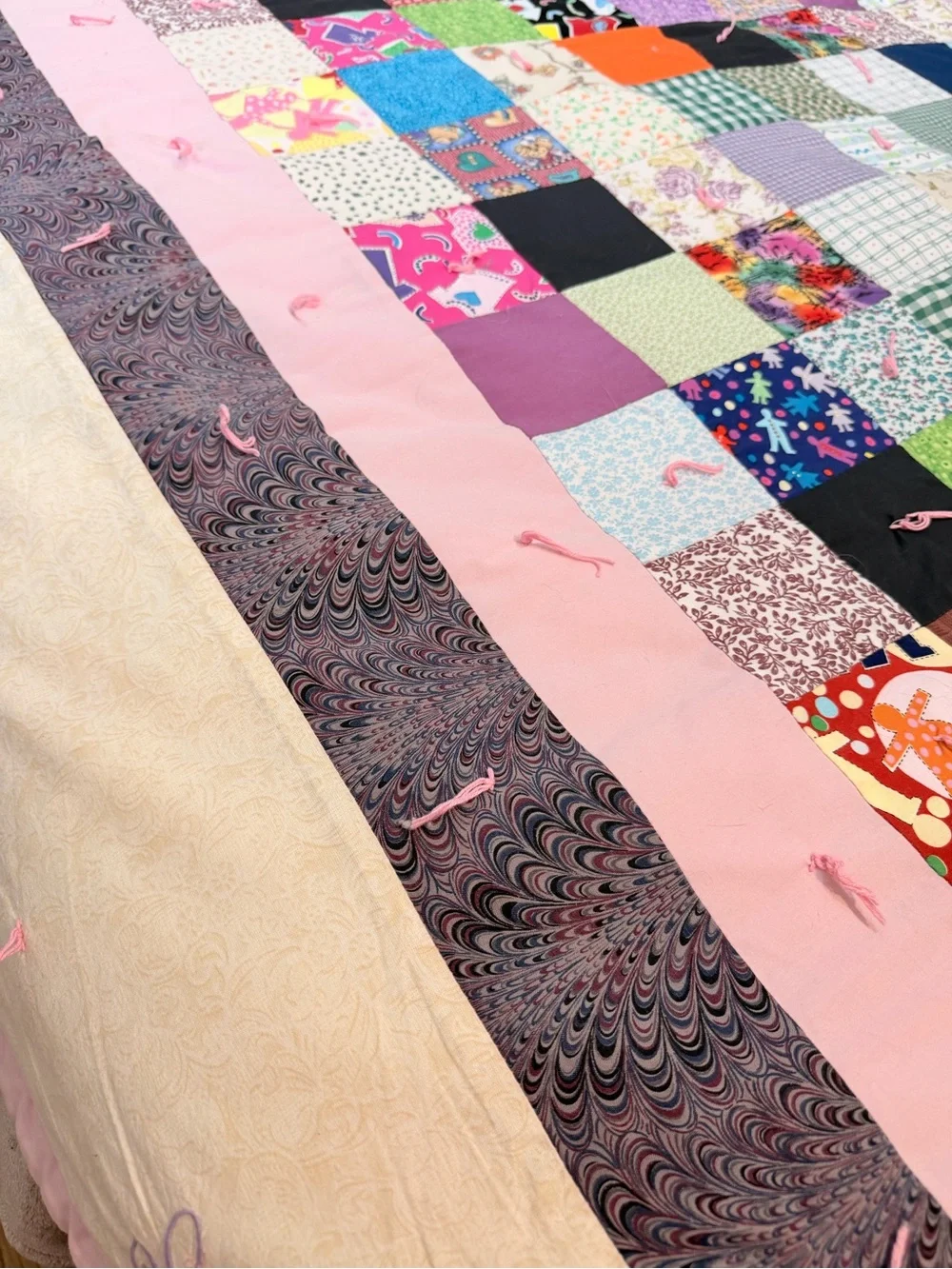 Hand crafted patchwork quilt with tan border